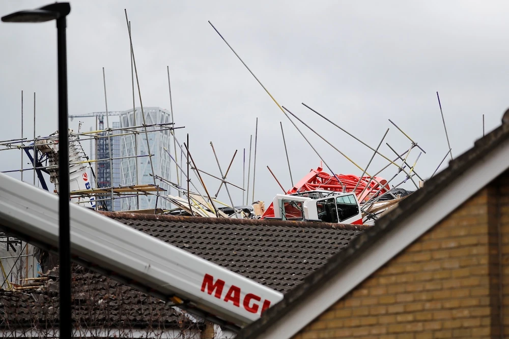 London’s Fire Brigade said on Wednesday a rescue operation had to be carried out after a 20-meter crane collapsed onto a block of apartments under development and two houses in the east of the city. (AFP)