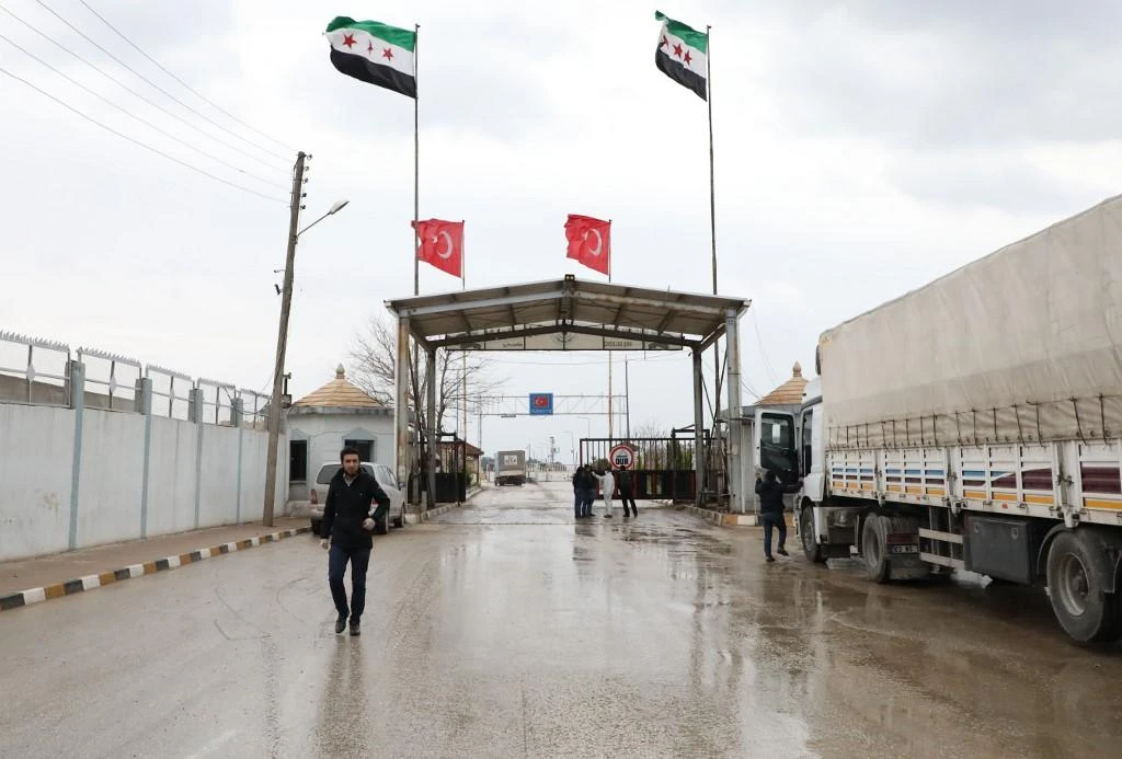 People crossing from Turkey into northern Syria walk through the Bab al-Salama border crossing. (File/AFP)