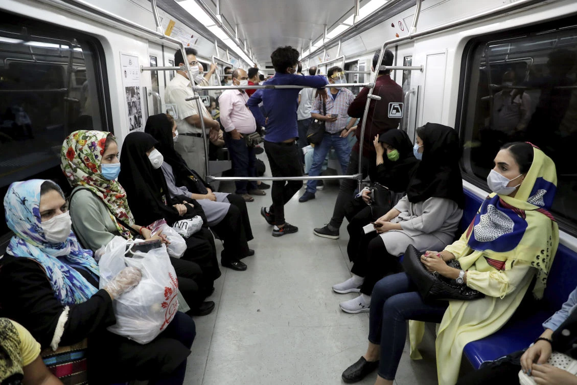 People wearing protective face masks to help prevent the spread of the coronavirus sit inside a train in Tehran, Iran, Wednesday, July 8, 2020. (AP)
