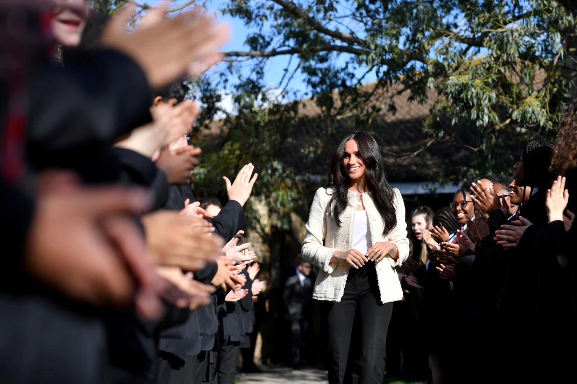 Britain's Meghan, Duchess of Sussex, smiles as she is welcomed by students to visit the Robert Clack School in Essex, Britain March 6, 2020, in support of International Women's Day. Picture taken March 6, 2020. (Reuters)