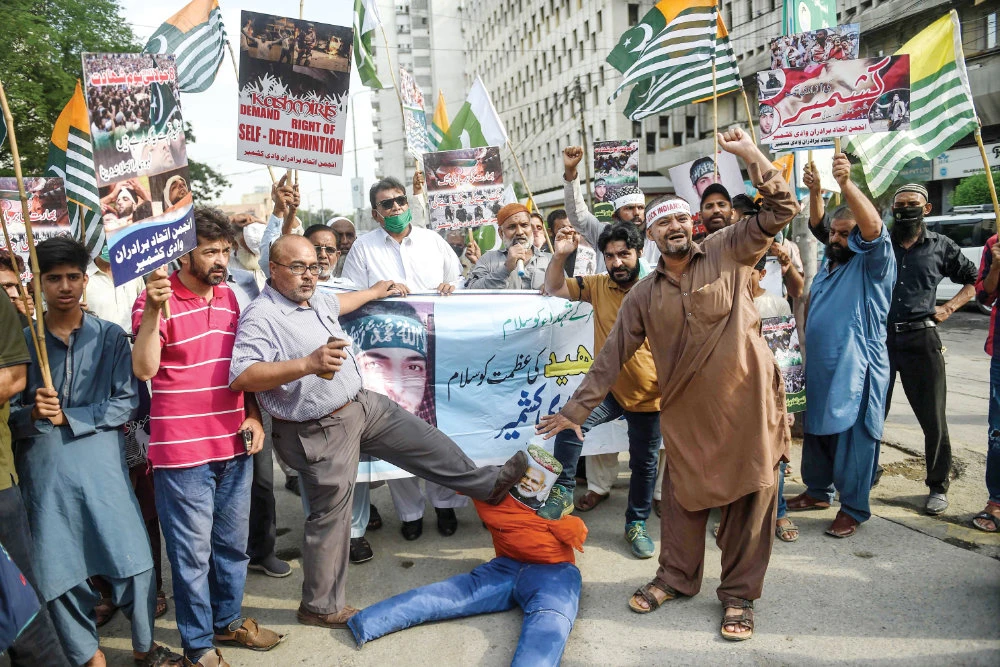 Demonstrators shout slogans during a protest on the fourth death anniversary of Indian Kashmiri militant leader Burhan Wani in Karachi. (AFP)