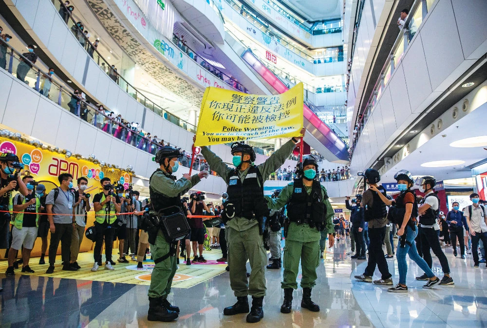 Riot police hold up a warning flag during a protest in Hong Kong. (AFP)