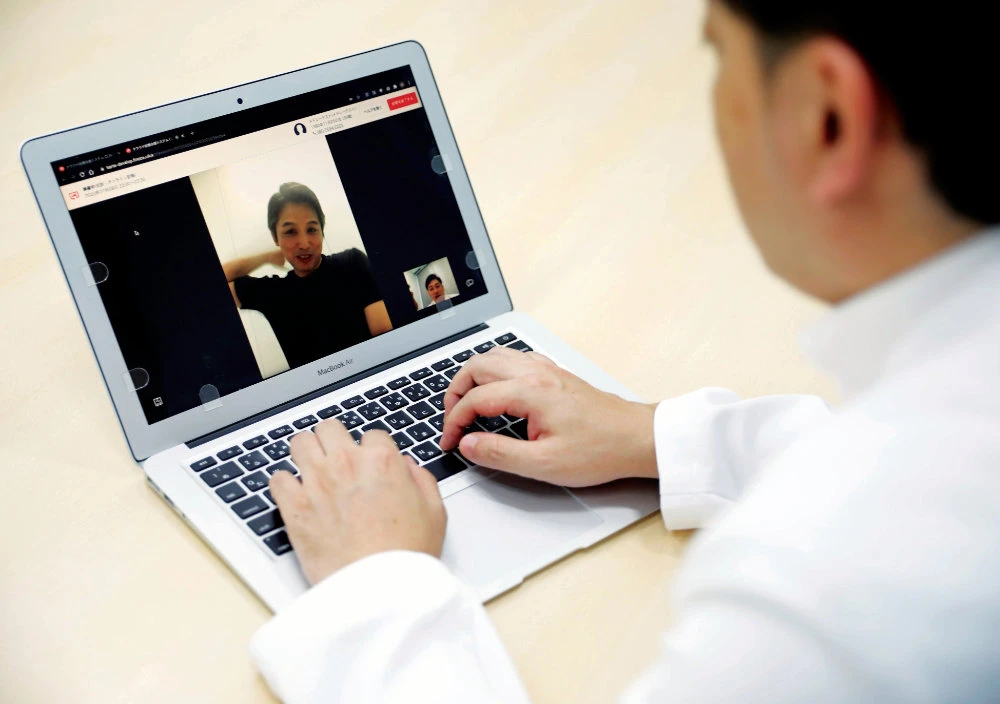 Dr. So Ishii demonstrates an online medical platform during an interview at his Kudanshita Ekimae CoCo Clinic, in Tokyo, Japan. (Reuters)