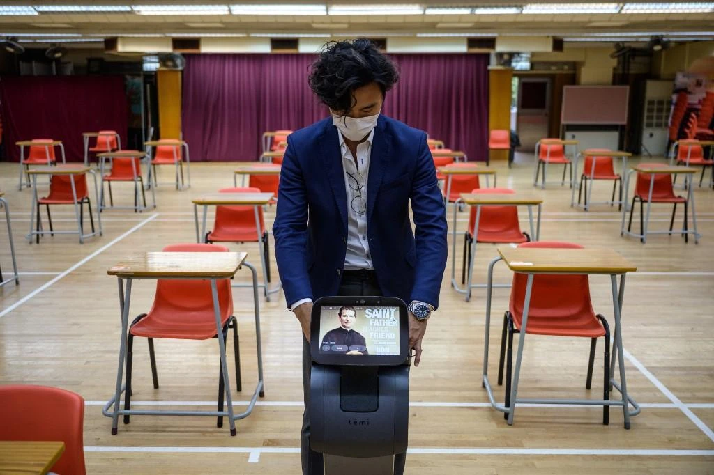 Above, a robot helps in the disinfection of desks and chairs at the Salesians of Don Bosco Ng Siu Mui Secondary School in Kwai Chung, Hong Kong on April 24, 2020. (AFP file photo)