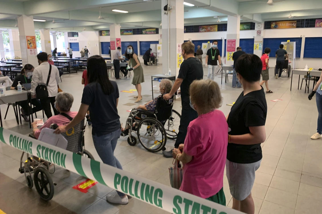 Singaporean voters wait for their turn inside the Dunearn Secondary School polling station on Friday, July 10, 2020. (AP)