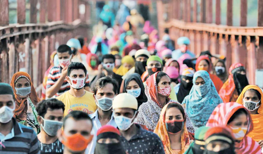 Garment workers after factories reopened in May in Dhaka. (Reuters/File)