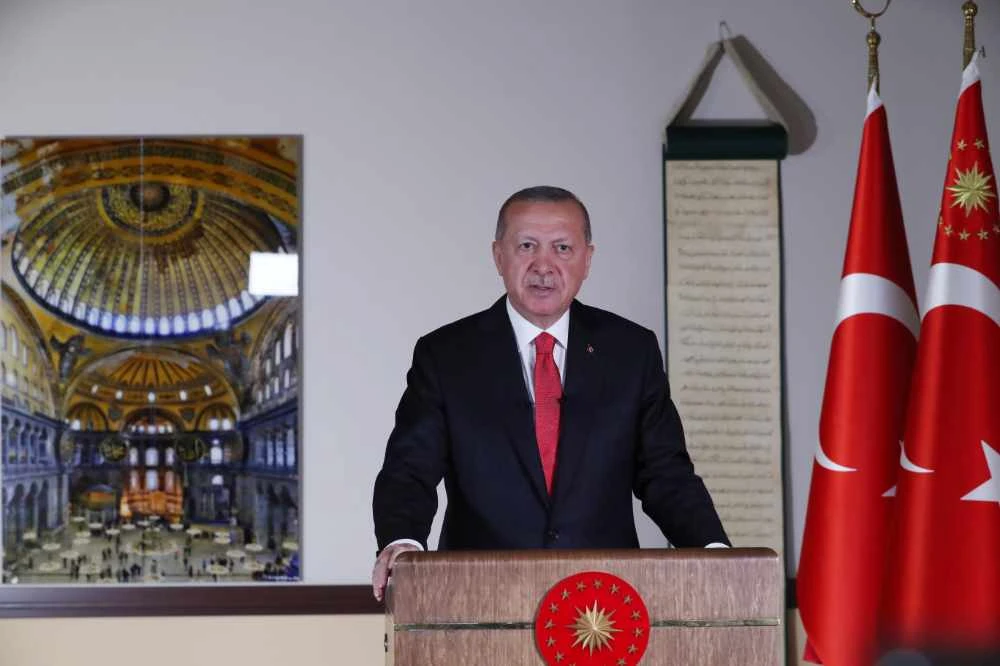 Turkish President Tayyip Erdogan, with a picture of Hagia Sophia or Ayasofya in the background, delivers a televised address to the nation in Ankara on July 10, 2020. (Turkish Presidential Press Office/Handout via REUTERS)