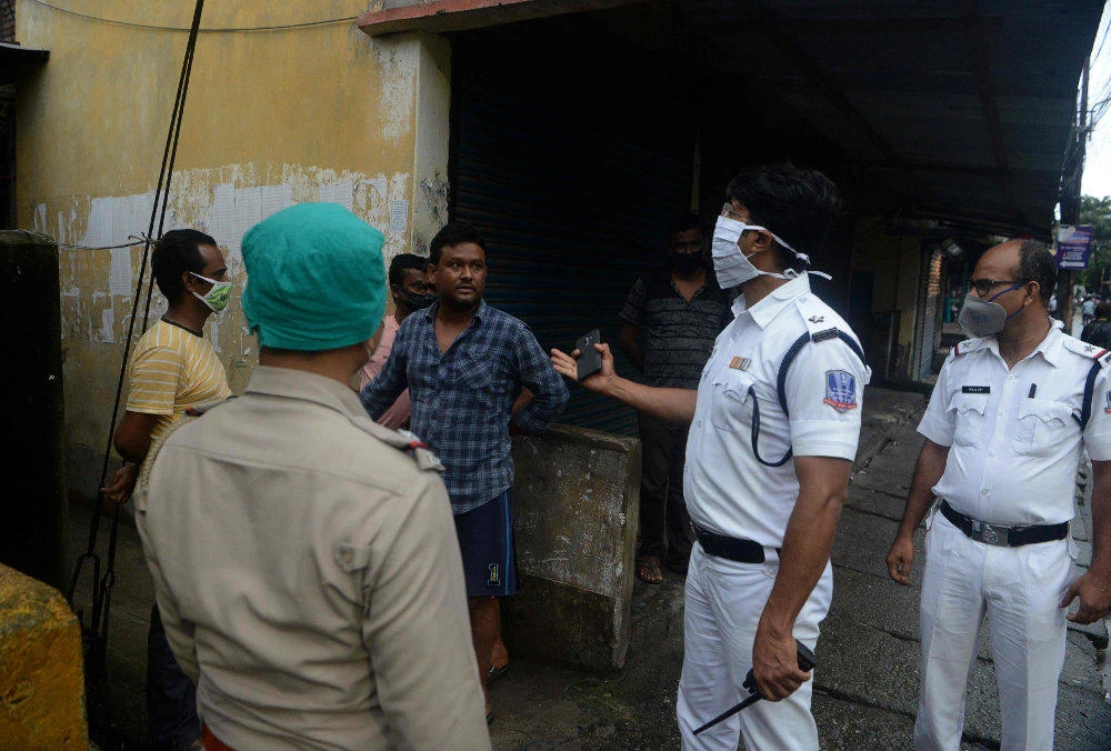 Police personnel patrol on a street shut after a recent lockdown was reimposed in nine wards under Siliguri Municipal area as a preventive measure against the COVID-19 coronavirus in Siliguri on July 10, 2020. (AFP / Diptendu Dutta)