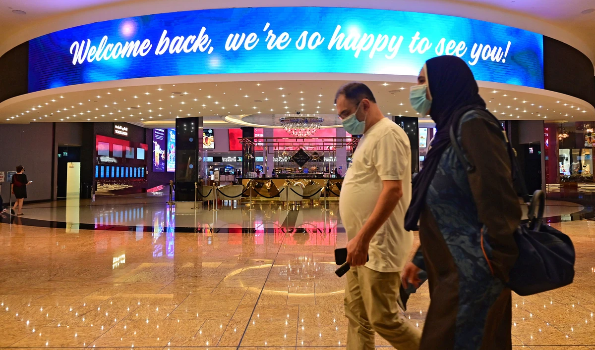 In this file photo, a man and a woman walk at the Dubai Mall after the Emirati authorities eased some of the restrictions that were put in place in a bid to stem the spread of the novel coronavirus, in Dubai on May 27, 2020. (AFP)