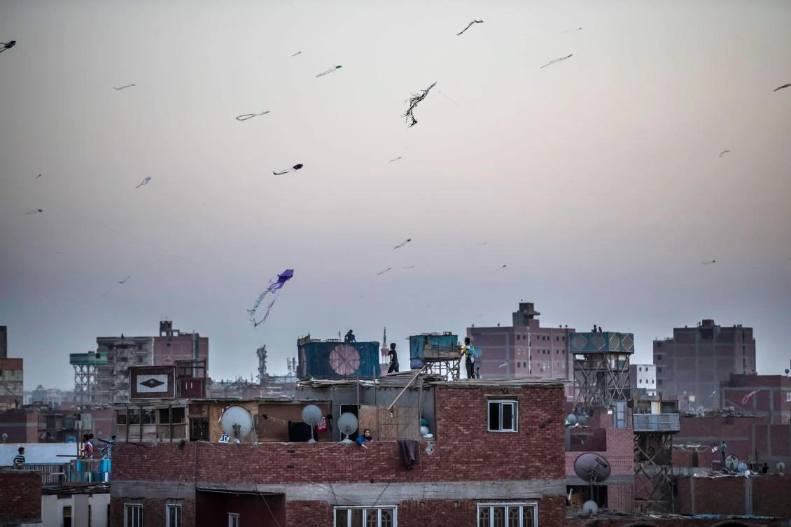Egyptian youths fly kites in the Saft el-Laban district of the Egyptian city of Giza, near the capital Cairo. (File/AFP)