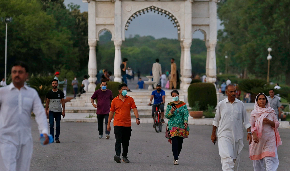 People wearing protective masks to help curb the spread of the coronavirus walk in a park in Islamabad, Pakistan, July 10, 2020. (AP)