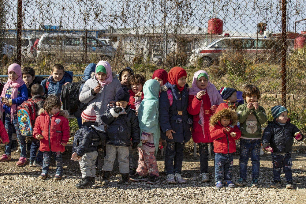 IIn this file photo taken on January 25, 2020, orphans from various nationalities gather at the Kurdish-run al-Hol camp, home to thousands of relatives of Islamic State group fighters, in the al-Hasakeh governorate in northeastern Syria, before being transported to the settlement of Roj. (AFP)