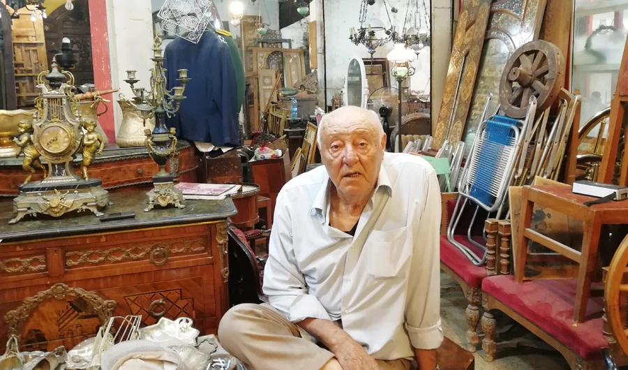Mohammed Mahmoud Hammoud, the oldest shop owner in the antique market, sits at the entrance of his shop. (Photo/Supplied)
