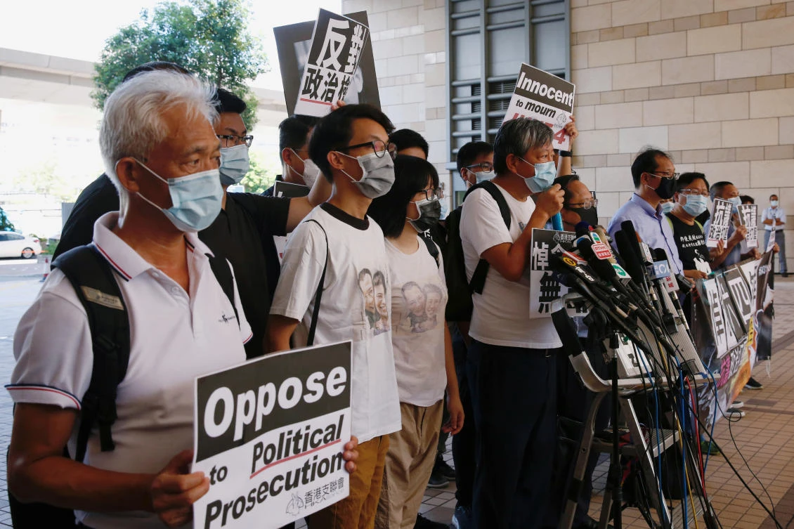 Pro-democracy activists outside the West Kowloon Courts before entering a courtroom to face charges related to illegal assembly during Tiananmen vigil in Hong Kong on July 13, 2020. (Reuters)
