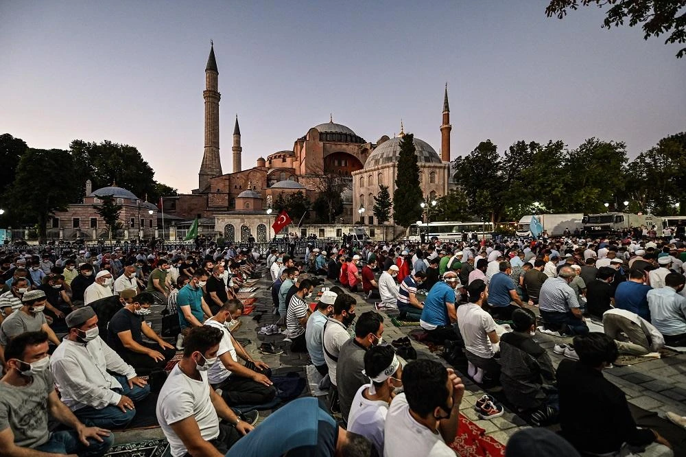 People pray outside the Hagia Sophia museum in Istanbul on July 10, 2020 after the monument’s status as a museum was turned back into a mosque. (AFP)