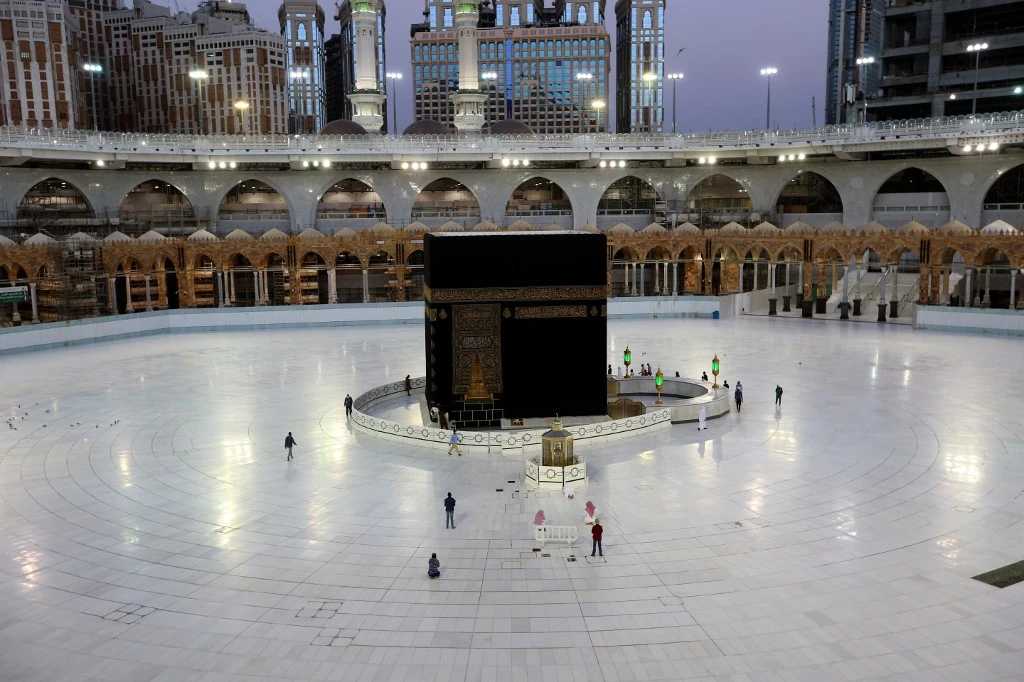 A picture taken June 23, 2020 shows a few worshippers performing morning prayers at the Kaaba at the Grand Mosque complex in Saudi Arabia's holy city of Mecca. Saudi Arabia has announced it will hold a "very limited" hajj this year, with pilgrims already in the kingdom allowed to perform the annual ritual as it moves to curb the biggest coronavirus outbreak in the Gulf. (AFP)