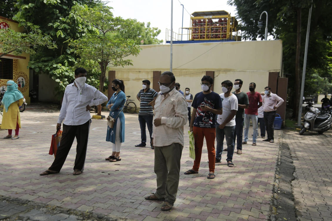 People stand in queues to get tested for COVID-19 at an urban health centre in Ahmedabad, India, Thursday, July 16, 2020. (AP)