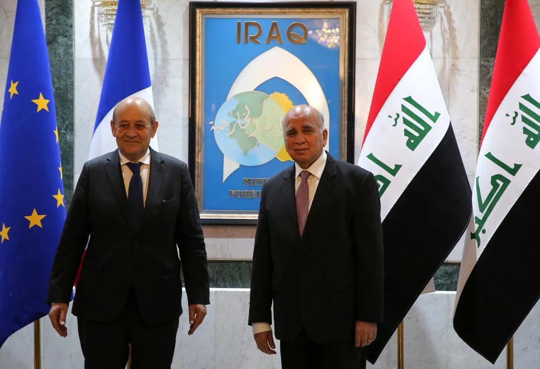 Iraqi Foreign Minister Fuad Hussein (R) receives his French couterpart Jean-Yves Le Drian in the Iraqi capital Baghdad, on July 16, 2020. (AFP)