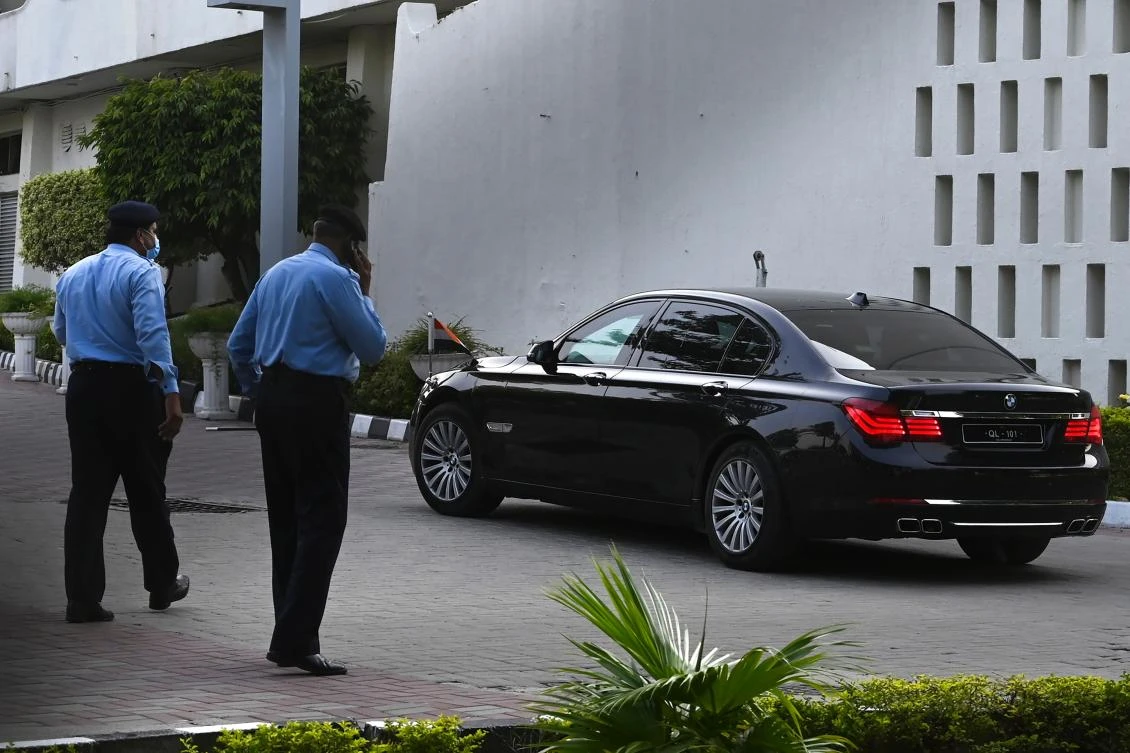 Police officers watch a car carrying Indian diplomats as they leave Pakistan's Foreign Ministry building after meeting with alleged Indian spy Commander Kulbhushan Jadhav in Islamabad on July 16, 2020. (AFP)