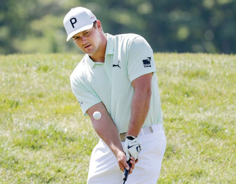 Bryson DeChambeau chips towards the green during a practice round for the Memorial golf tournament on Wednesday. (AP)