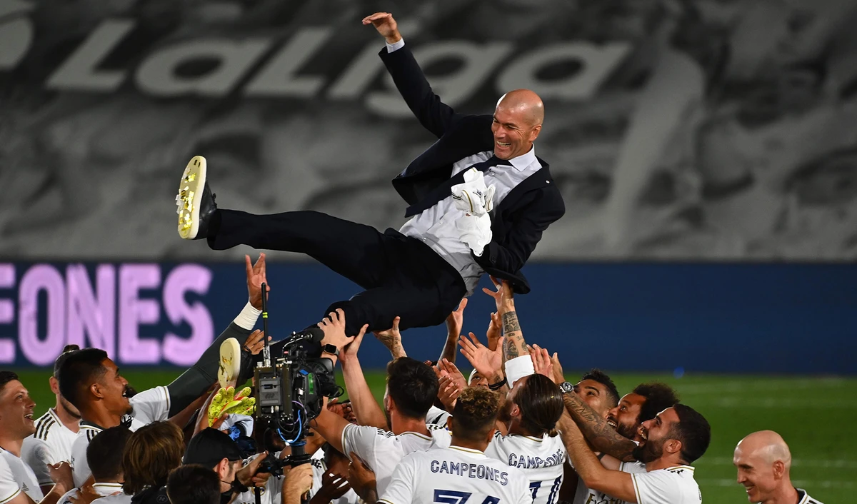 Real Madrid's players toss their French coach Zinedine Zidane after winning the Liga title after the Spanish League football match between Real Madrid CF and Villarreal CF at the Alfredo di Stefano stadium in Valdebebas, on the outskirts of Madrid, on July 16, 2020. (AFP)