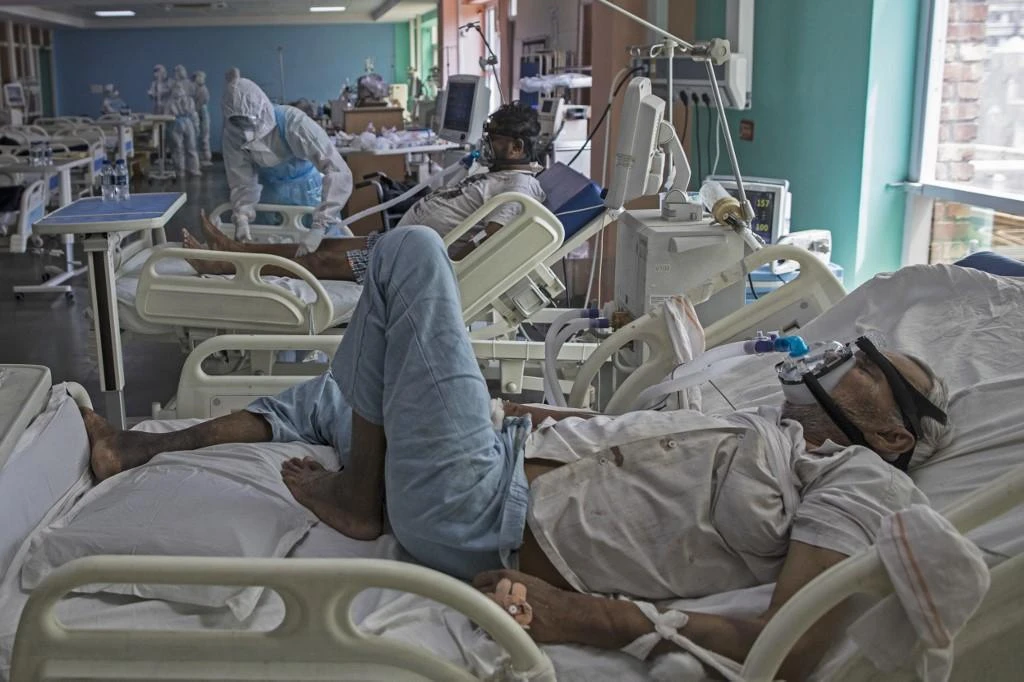 Coronavirus patients rest on their beds at the Intensive Care Unit of the Sharda Hospital, in Greater Noida. (AFP)