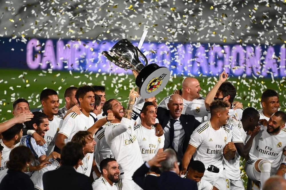 Real Madrid's players celebrate winning the Liga title after the Spanish League football match between Real Madrid CF and Villarreal CF at the Alfredo di Stefano stadium in Valdebebas, on the outskirts of Madrid. (AFP)