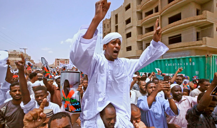 Protesters chant slogans as they march during a demonstration along Al-Siteen Street in the Khartoum East district of Sudan’s capital on Friday. (AFP)