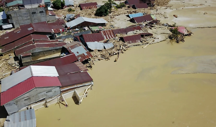 This aerial handout picture taken and released on July 17, 2020 by Indonesian mitigation management agency (BNPB) shows houses buried in mud in North Luwu, South Sulawesi, after several rivers burst their banks following torrential rains in the region. (AFP)