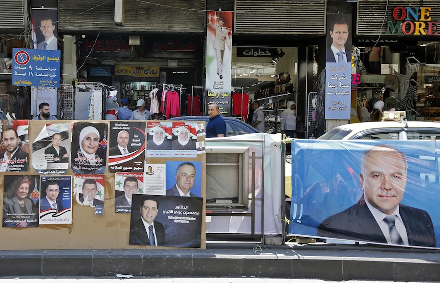 A picture taken on July 15, 2020, shows campaign posters of candidates for the People's Council of Syria in the capital Damascus. (File/AFP)