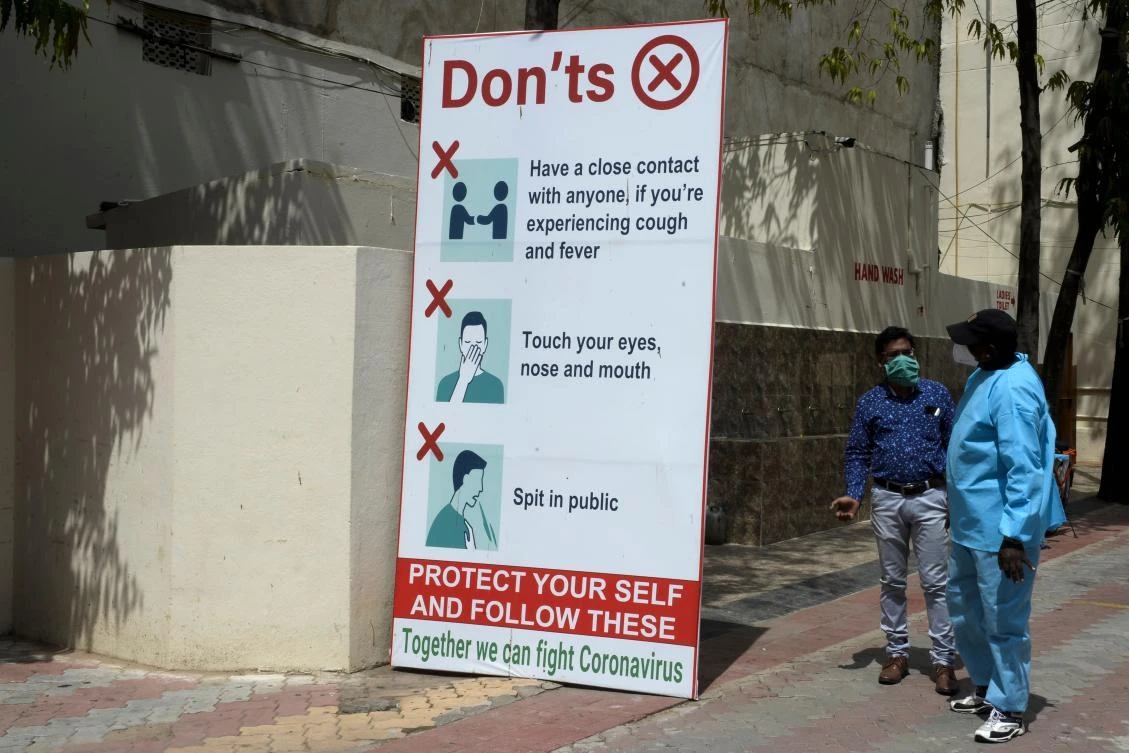 Above, a banner to prevent the spread of coronavirus is placed at the entrance of a church in Hyderabad on July 19, 2020. (AFP)