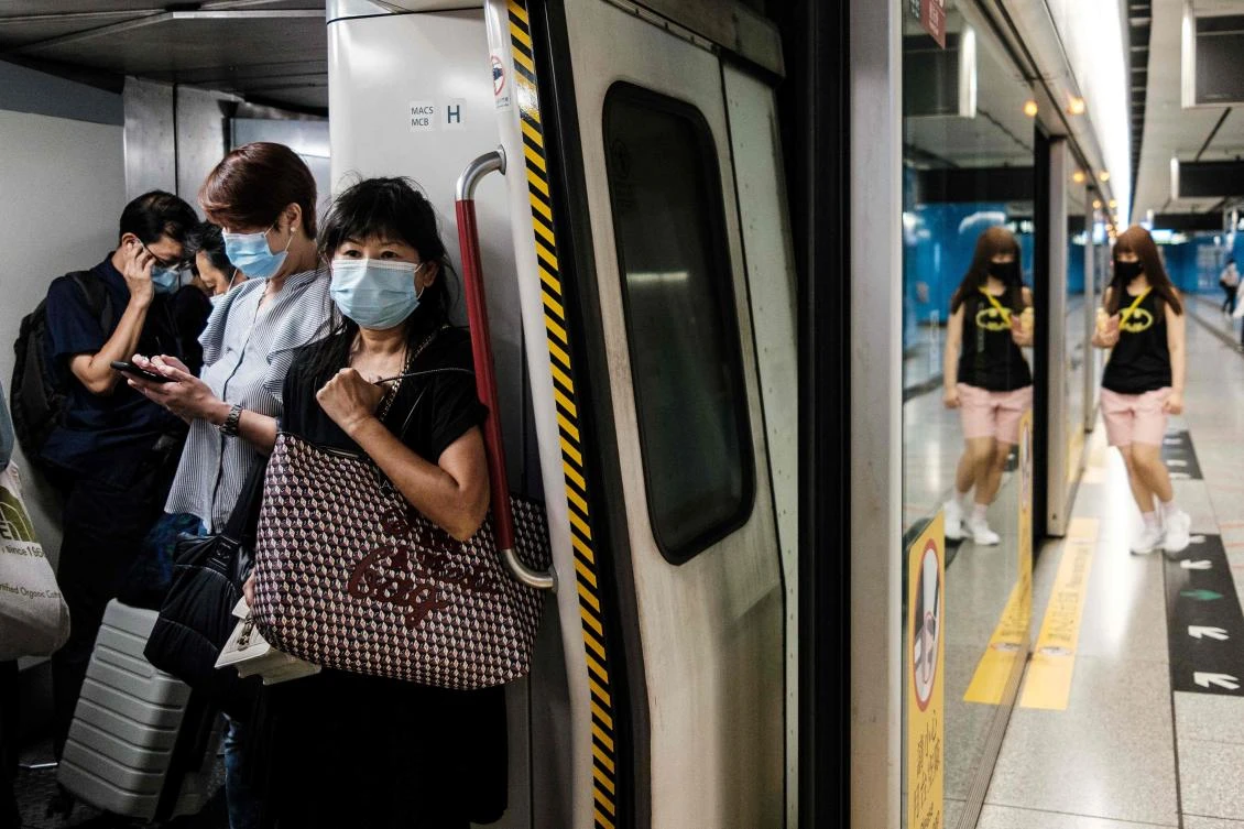 Hong Kong recorded more than 100 coronavirus cases in the past 24 hours, forcing the city to tighten social distancing measures. (AFP)
