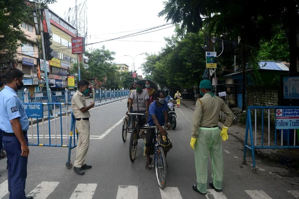 Indian police stop motorists on a street after a new lockdown was imposed as a preventive measure against the spread of the coronavirus in Siliguri on July 19, 2020. (AFP)