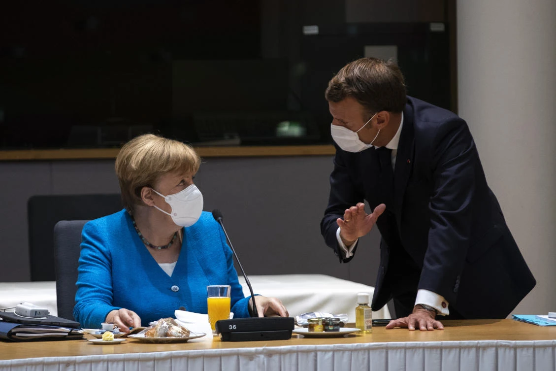 German Chancellor Angela Merkel, left, speaks with French President Emmanuel Macron during a meeting on the sidelines of an EU summit in Brussels, Saturday, July 18, 2020. Leaders from 27 European Union nations meet face-to-face for a second day of an EU summit to assess an overall budget and recovery package spread over seven years estimated at some 1.75 trillion to 1.85 trillion euros. (AP)