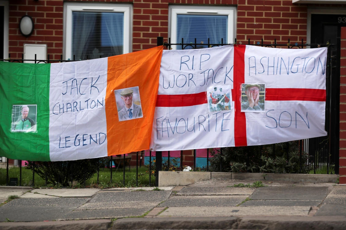 English and Irish flags pictured during the funeral procession of Jack Charlton, a World Cup winner with England and former Republic of Ireland boss, Ashington, Northumberland, Britain, July 21, 2020. (Reuters)