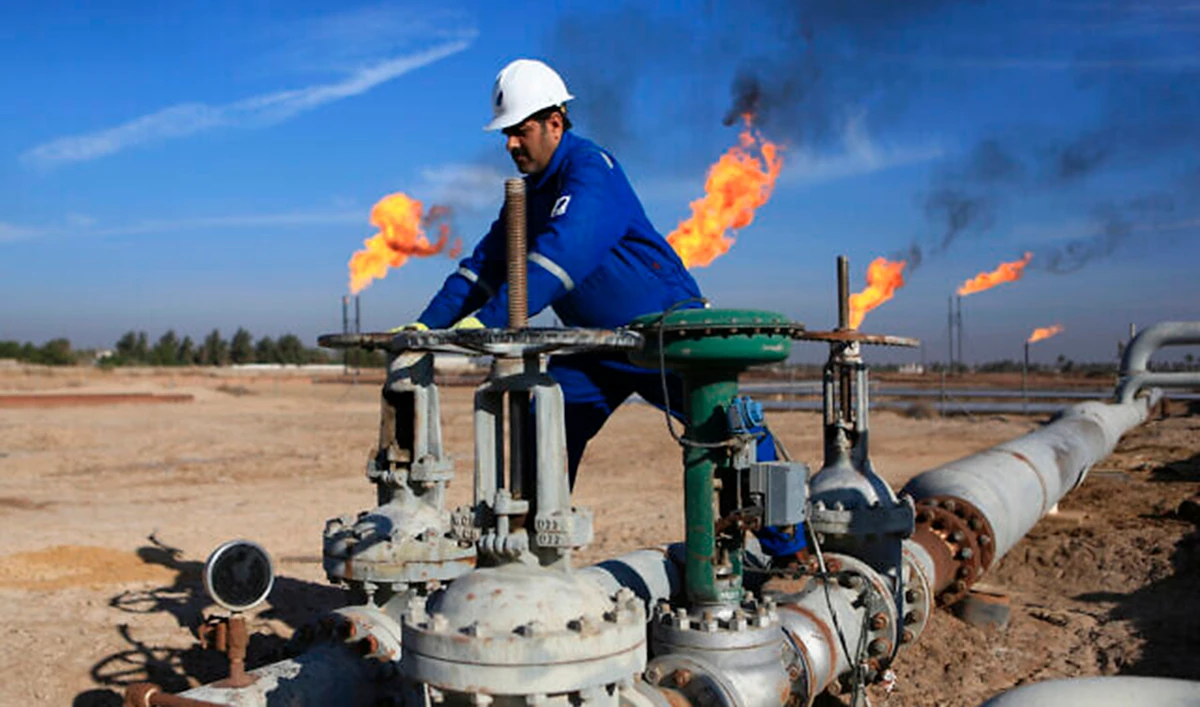 In this file photo, a worker operates valves in Nihran Bin Omar field north of Basra, Iraq. (AP)