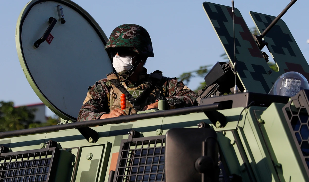 A police officer on board an armored vehicle patrols a neighborhood to enforce the reimposed lockdown amid a spike in the coronavirus disease (COVID-19) cases, in Navotas, Metro Manila, Philippines. (Reuters)