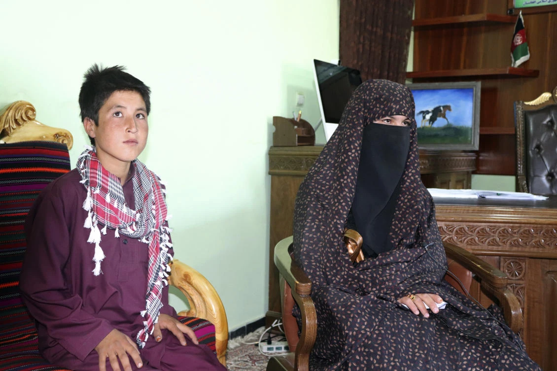 Qamar Gul, 16, right, and her brother Habibullah, 12, pose for photograph in the governor's office in Feroz Koh, the provincial capital of Ghor province, in western Afghanistan, Tuesday, July 21, 2020. (AP)