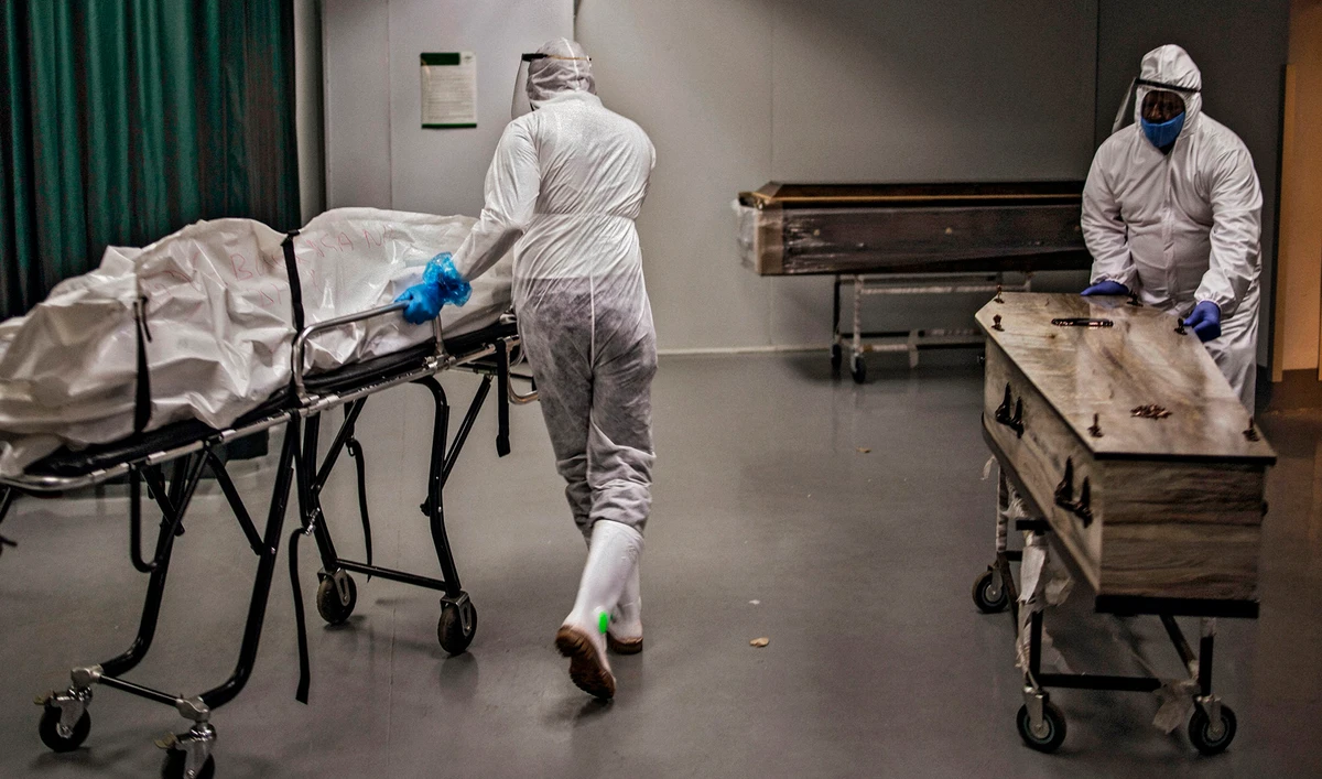 Undertakers move remains of COVID-19 coronavirus patients at the AVBOB funeral house in Soweto, on July 21, (AFP)