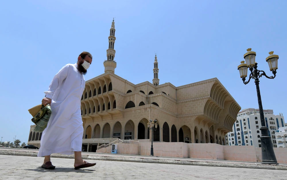 A worshipper leaves a mosque following players in the emirate of Sharjah in the United Arab Emirates. (File/AFP)
