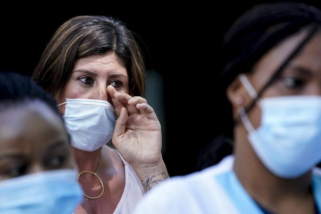 An healthcare worker wipe a tear as she take part in a protest calling for better work conditions, and more support for their sector at the Joseph Bracops Hospital in Brussels on June 22, 2020. (File/AFP)