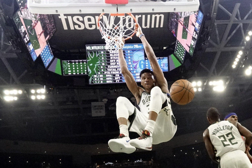 In this Feb. 22, 2020, file photo, Milwaukee Bucks' Giannis Antetokounmpo dunks during the first half of an NBA basketball game against the Philadelphia 76ers in Milwaukee. (AP Photo/Morry Gash, File)