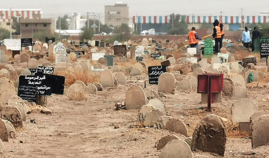 Members of a forensic team are seen at a cemetery, where a mass grave of conscripts killed in 1998 was discovered, in Sahafa, near Khartoum. (AFP)