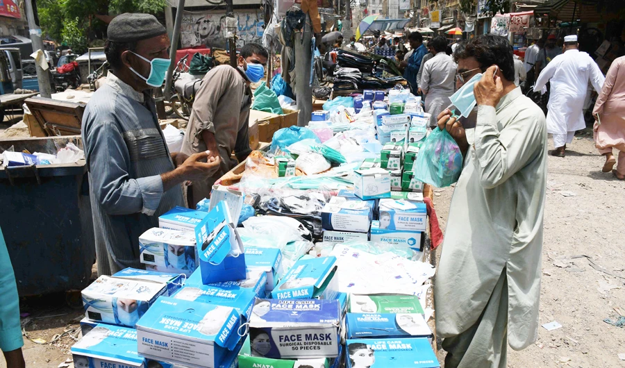 A street vendor sells face masks at Bolton Market in Karachi. (AN photo)