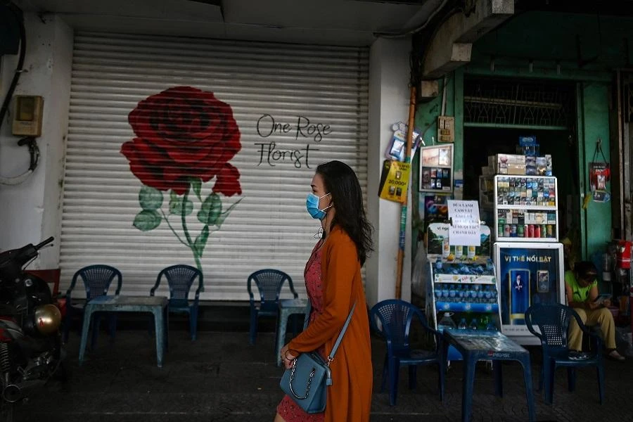 A woman walks past a closed shop along a street in Ho Chi Minh City on June 27, 2020. (File/AFP)