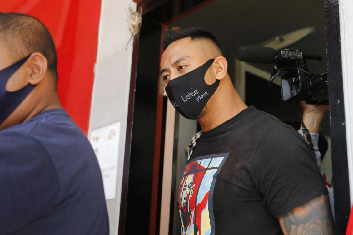 Australian national William Cabantog, right, is escorted by an Indonesian prison guard as he leaves Kerobokan prison in Bali, Indonesia on Saturday, July 25, 2020. Cabantog is released from the prison where he has served to twelve months. (AP)