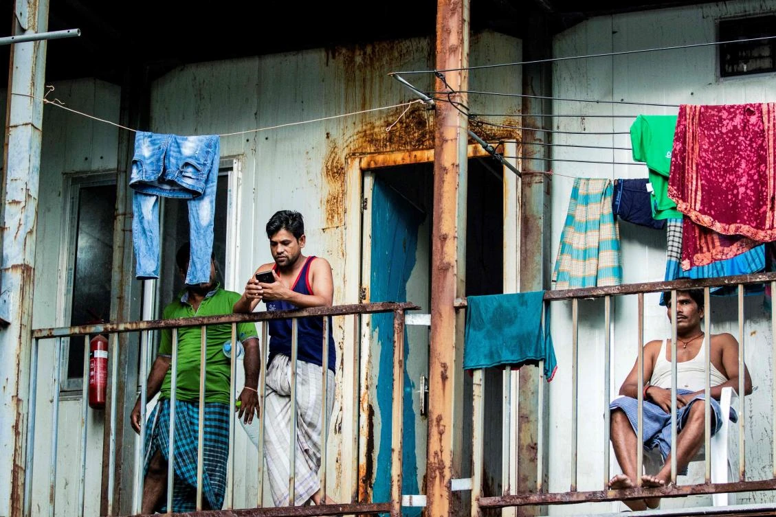 In this file photo taken on May 9, 2020, foreign workers from Bangladesh gather in their accommodation block after being put under quarantine to contain the spread of the COVID-19 coronavirus, in Male. (AFP)