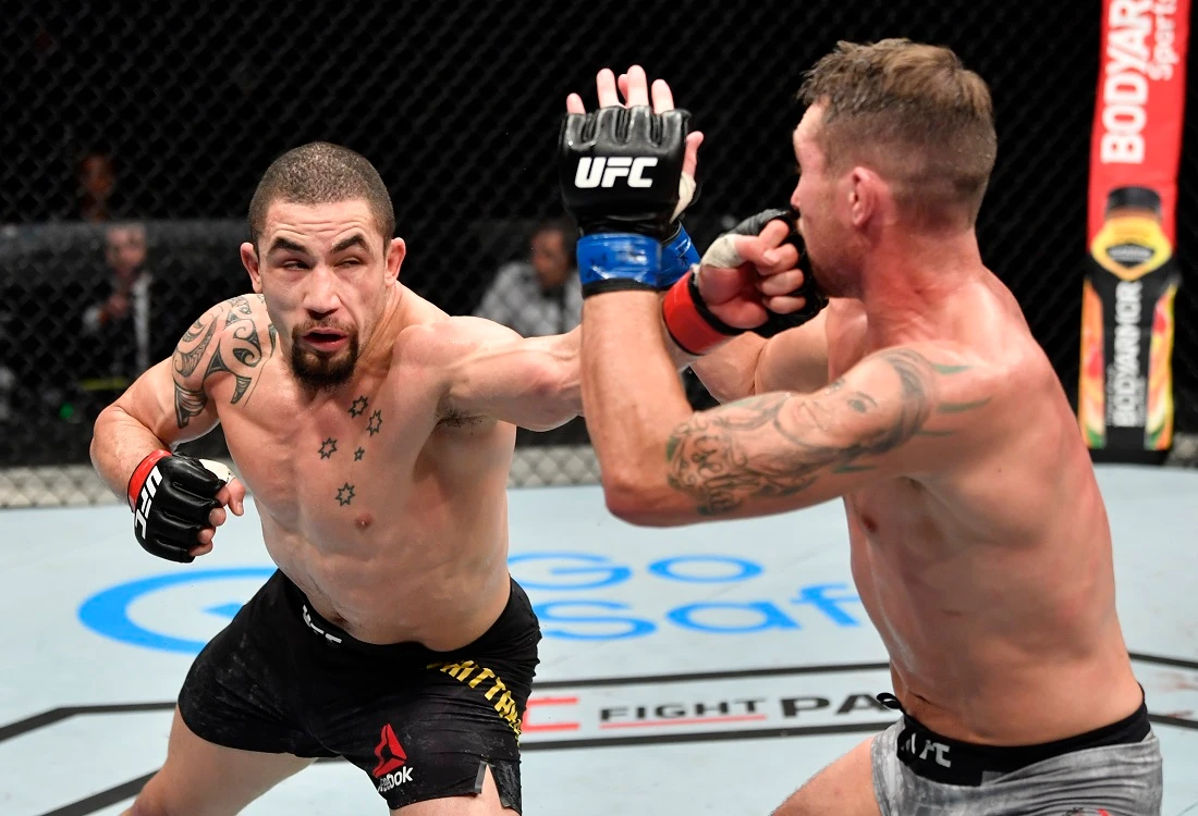 Robert Whittaker strikes a blow during his unanimous win over Darren Till. (Getty Images/UFC)