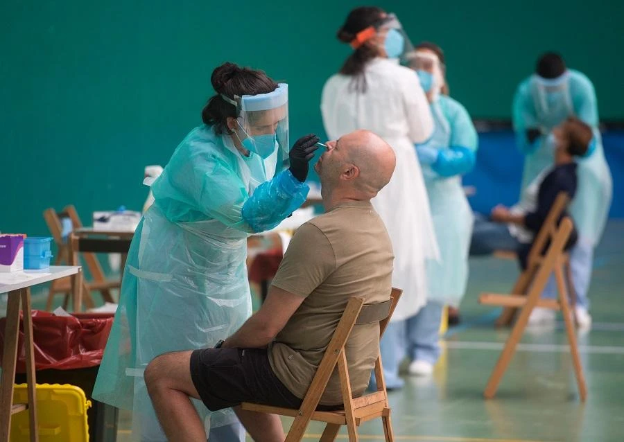 A healthcare worker uses a swab to collect a sample at a temporary testing centre for the novel coronavirus in the Spanish Basque city of Getaria on July 15, 2020. (File/AFP)