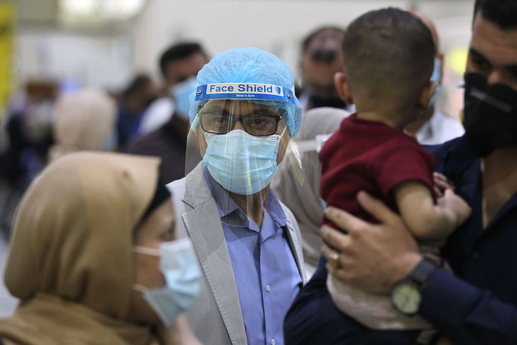 Image Caption : Passengers wearing protective masks wait for flights at the departure hall of Baghdad international airport following its reopening on July 23, 2020, after a closure forced by the coronavirus pandemic restrictions aimed at preventing the spread of the deadly COVID-19 illness in Iraq. (AFP )